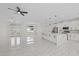 Bright, open-concept living room with white marble floors and modern lighting fixtures at 7372 Madrid Rd, Weeki Wachee, FL 34613