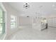 Open-concept living room featuring large windows and sleek, bright marble flooring at 7372 Madrid Rd, Weeki Wachee, FL 34613