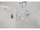 Spacious living area featuring an open layout, white marble flooring, and views into the kitchen at 7372 Madrid Rd, Weeki Wachee, FL 34613