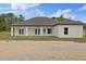 Rear exterior showcasing covered patio and spacious backyard at 7372 Madrid Rd, Weeki Wachee, FL 34613