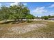 Picture of the yard showing large shade trees and the exterior of the home at 7372 Madrid Rd, Weeki Wachee, FL 34613
