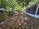 View of the back yard with plenty of space and a screened in patio at 7740 Sagebrush Dr, Port Richey, FL 34668