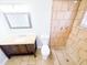 Bathroom features a vanity, toilet, and tiled shower with a rain shower head at 7740 Sagebrush Dr, Port Richey, FL 34668
