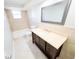 Bathroom features a vanity, toilet, tub, and large mirror at 7740 Sagebrush Dr, Port Richey, FL 34668