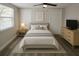 Cozy bedroom features a ceiling fan, natural light, and neutral decor at 7740 Sagebrush Dr, Port Richey, FL 34668
