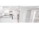 Bright open concept kitchen with granite countertops, stainless steel appliances, and white cabinets at 7740 Sagebrush Dr, Port Richey, FL 34668