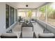 Inviting sunroom with neutral colors, comfortable seating, and outdoor views at 7740 Sagebrush Dr, Port Richey, FL 34668