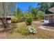 Exterior backyard shot with wooden shed and lush flowering plants at 7802 N 53Rd St, Tampa, FL 33617