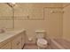 Bathroom featuring floral wallpaper, tiled walls, and sink at 7802 N 53Rd St, Tampa, FL 33617