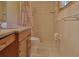 Bright bathroom features granite vanity, white tiled shower, and decorative shower curtain at 7802 N 53Rd St, Tampa, FL 33617