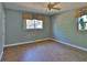 Cozy bedroom with a large window, ceiling fan, and neutral paint, creating a warm ambiance at 7802 N 53Rd St, Tampa, FL 33617