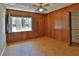 Bedroom featuring wood paneling, ceiling fan, window with shutters, and closet at 7802 N 53Rd St, Tampa, FL 33617