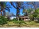 Quaint single-story home set amid lush greenery and mature trees, providing a serene backdrop at 7802 N 53Rd St, Tampa, FL 33617
