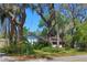 Charming residence surrounded by mature trees and lush landscaping, creating a private setting at 7802 N 53Rd St, Tampa, FL 33617