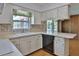 Bright kitchen features white cabinets, a mosaic tile backsplash, and plenty of counter space at 7802 N 53Rd St, Tampa, FL 33617