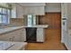 Spacious kitchen with plenty of counter space and stylish white cabinets, seamlessly blending with the dining area at 7802 N 53Rd St, Tampa, FL 33617