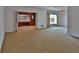 Large living room with natural light, complemented by built-in shelving and cozy carpeting at 7802 N 53Rd St, Tampa, FL 33617