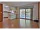 Bright living area featuring wood floors and access to a screened lanai, enhancing indoor-outdoor living at 7802 N 53Rd St, Tampa, FL 33617