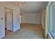 Open-concept living space with access to kitchen featuring carpeting and ample natural light at 7802 N 53Rd St, Tampa, FL 33617