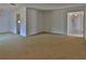 Bright and airy living room with neutral carpeting, seamlessly transitioning to different living spaces at 7802 N 53Rd St, Tampa, FL 33617