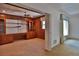 Home office featuring ceiling fan, built-in shelving, wooden desk and paneling at 7802 N 53Rd St, Tampa, FL 33617