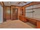 Home office featuring ceiling fan, built-in shelving, wooden desk and paneling at 7802 N 53Rd St, Tampa, FL 33617