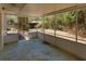 Covered patio with screened enclosure, looking out to the backyard with foliage at 7802 N 53Rd St, Tampa, FL 33617