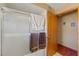 Bathroom featuring a bathtub and shower with sliding glass doors, a towel rack and wooden door at 8195 Wooden Dr, Spring Hill, FL 34606