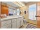 Bathroom featuring a window, vanity, toilet and towel rack at 8195 Wooden Dr, Spring Hill, FL 34606