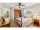 Bedroom featuring a four poster bed, dresser, neutral carpet and walls, and natural light at 8195 Wooden Dr, Spring Hill, FL 34606