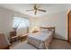 Bedroom featuring a window, nightstand and floral bedspread at 8195 Wooden Dr, Spring Hill, FL 34606