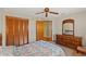 Bedroom featuring a dresser with mirror, closet and floral bedspread at 8195 Wooden Dr, Spring Hill, FL 34606