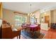 Dining area featuring natural light, wood floors, a chandelier, and traditional furnishings at 8195 Wooden Dr, Spring Hill, FL 34606