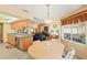 Open-concept eat-in kitchen featuring wood cabinets, granite countertops, stainless appliances, and natural light at 8195 Wooden Dr, Spring Hill, FL 34606