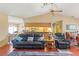 Comfortable living room featuring hardwood floors, a ceiling fan, an open floor plan, and modern appliances at 8195 Wooden Dr, Spring Hill, FL 34606