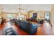 Spacious open-concept living room with dining area, hardwood floors, and multiple ceiling fans at 8195 Wooden Dr, Spring Hill, FL 34606