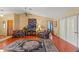 Cozy living room with vaulted ceilings, hardwood floors, a ceiling fan, and comfortable seating at 8195 Wooden Dr, Spring Hill, FL 34606