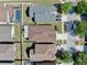 An aerial view shows houses in a neighborhood with manicured lawns and driveways on a sunny day at 8603 Sandy Plains Dr, Riverview, FL 33578