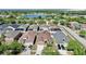Aerial shot showcasing houses in a vibrant community near a lake, adorned with lush greenery and scenic beauty at 8603 Sandy Plains Dr, Riverview, FL 33578