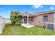 Exterior shot of the house showcasing a screened-in porch and well-kept lawn at 8603 Sandy Plains Dr, Riverview, FL 33578