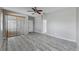 Neutral bedroom with wood floors, a ceiling fan, vertical blinds and an attached bathroom at 8603 Sandy Plains Dr, Riverview, FL 33578