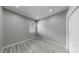 Neutral bedroom with wood-look flooring, window with blinds, and closet at 8603 Sandy Plains Dr, Riverview, FL 33578