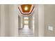 Inviting entrance hallway showcasing neutral walls, decorative ceiling, and light wood-look flooring throughout at 8603 Sandy Plains Dr, Riverview, FL 33578