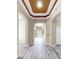 Hallway with wood-look floors leads to other rooms in the home at 8603 Sandy Plains Dr, Riverview, FL 33578