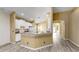 Inviting kitchen with bar seating, open to living area, with white appliances, and tile flooring at 8603 Sandy Plains Dr, Riverview, FL 33578