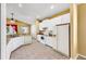 Kitchen with white appliances, tile floor, and a sunny window overlooking the backyard at 8603 Sandy Plains Dr, Riverview, FL 33578