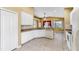 Bright kitchen features white cabinetry, tile floors, granite counters, and modern appliances at 8603 Sandy Plains Dr, Riverview, FL 33578