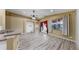 Inviting living room with wood floors, ceiling fan, and abundant natural light from the French doors and window at 8603 Sandy Plains Dr, Riverview, FL 33578