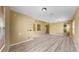 Spacious living room features wood-look floors and neutral wall color at 8603 Sandy Plains Dr, Riverview, FL 33578