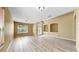 Spacious living room showcases wood-look floors, neutral wall color, and lots of natural light at 8603 Sandy Plains Dr, Riverview, FL 33578